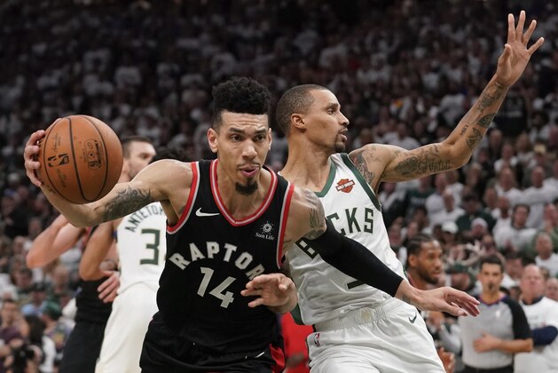 Toronto Raptors' Danny Green is fouled by Milwaukee Bucks' George Hill during the second half of Game 1 of the NBA Eastern Conference basketball playoff finals Wednesday, May 15, 2019, in Milwaukee. The Bucks won 108-100 to take a 1-0 lead in the series. (AP Photo/Morry Gash)