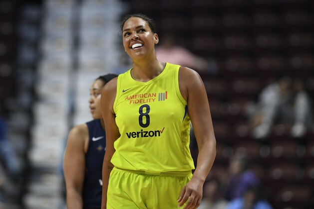 FILE - In this May 8, 2018, file photo, Dallas Wings' Liz Cambage smiles during a preseason WNBA basketball game, in Uncasville, Conn. Cambage, of Australia, scored 53 points to set a WNBA record Tuesday, July 17, 2018, leading the Dallas Wings to a 104-87 victory over the New York Liberty. (AP Photo/Jessica Hill, File)