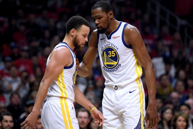 LOS ANGELES, CALIFORNIA - APRIL 26:  Kevin Durant #35 of the Golden State Warriors speaks with Stephen Curry #30 in the first half against the LA Clippers during Game Six of Round One of the 2019 NBA Playoffs at Staples Center on April 26, 2019 in Los Angeles, California. (Photo by Harry How/Getty Images)  NOTE TO USER: User expressly acknowledges and agrees that, by downloading and or using this photograph, User is consenting to the terms and conditions of the Getty Images License Agreement.