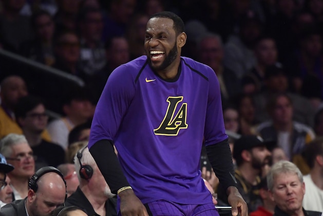 Los Angeles Lakers forward LeBron James laughs as he waits to check in to the team's NBA basketball game against the Charlotte Hornets during the second half Friday, March 29, 2019, in Los Angeles. The Lakers won 129-115. (AP Photo/Mark J. Terrill)