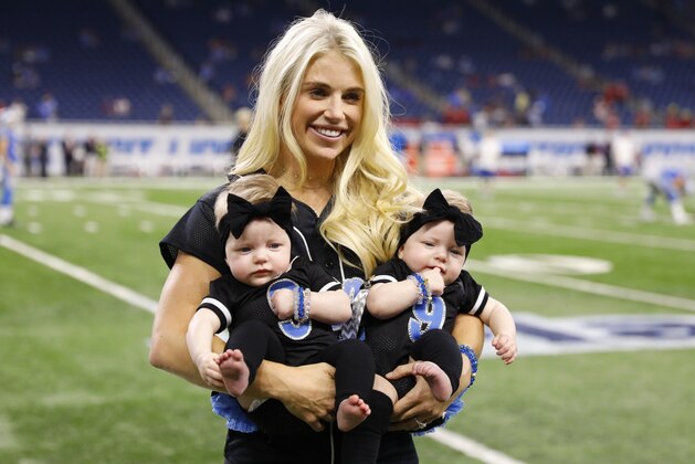 FILE - In this Sept. 24, 2017, file photo, Kelly Stafford, wife of Detroit Lions quarterback Matthew Stafford, holds the couple's twins Sawyer, left, and Chandler during pre-game of an NFL football game against the Atlanta Falcons, in Detroit. Kelly Stafford plans to have surgery to remove a brain tumor. Stafford shared the details Wednesday, April 3, 2019, on her Instagram account. She says an MRI showed the tumor on cranial nerves after she had vertigo spells within the last year. (AP Photo/Rick Osentoski, File)