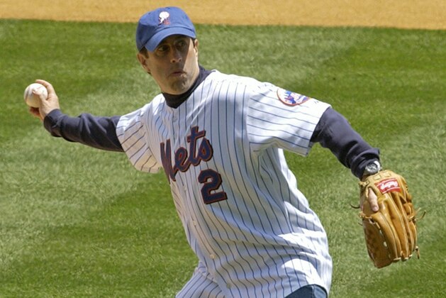 File-This May 22, 2005 file photo shows Jerry Seinfeld throwing out the first pitch before the rubber game of the Subway Series between the New York Yankees and New York Mets at Shea Stadium in New York. Stop me if you've heard this one before. Seinfeld will join the broadcast crew Tuesday for the New York Mets, a team that is 15 games below .500 and with little to laugh about this season. (AP Photo/Bill Kostroun, File)