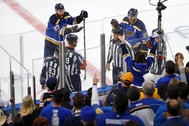 ST LOUIS, MISSOURI - MAY 15: Matt MacPherson #83, linesman Jonny Murray #95 and referee Dan O'Rourke #9 discuss a possible hand pass game winning overtime goal scored by Erik Karlsson #65 of the San Jose Sharks against the St. Louis Blues in overtime of Game Three of the Western Conference Finals during the 2019 NHL Stanley Cup Playoffs at Enterprise Center on May 15, 2019 in St Louis, Missouri. (Photo by Dilip Vishwanat/Getty Images)