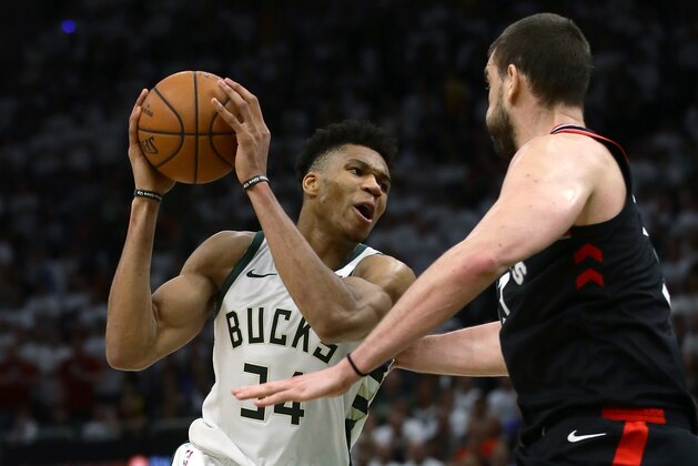 MILWAUKEE, WISCONSIN - MAY 15:  Giannis Antetokounmpo #34 of the Milwaukee Bucks dribbles the ball while being guarded by Marc Gasol #33 of the Toronto Raptors in the fourth quarter in Game One of the Eastern Conference Finals of the 2019 NBA Playoffs at the Fiserv Forum on May 15, 2019 in Milwaukee, Wisconsin. NOTE TO USER: User expressly acknowledges and agrees that, by downloading and or using this photograph, User is consenting to the terms and conditions of the Getty Images License Agreement. (Photo by Jonathan Daniel/Getty Images)