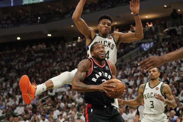 Toronto Raptors' Kawhi Leonard tries to shoot in front of Milwaukee Bucks' Giannis Antetokounmpo during the second half of Game 1 of the NBA Eastern Conference basketball playoff finals Wednesday, May 15, 2019, in Milwaukee. The Bucks won 108-100 to take a 1-0 lead in the series. (AP Photo/Morry Gash)