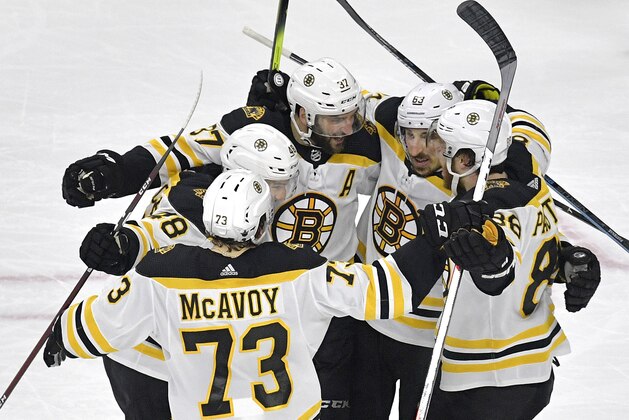 RALEIGH, NORTH CAROLINA - MAY 16: Patrice Bergeron #37 of the Boston Bruins celebrates with his teammates after scoring on Curtis McElhinney #35 of the Carolina Hurricanes during the second period in Game Four of the Eastern Conference Finals during the 2019 NHL Stanley Cup Playoffs at PNC Arena on May 16, 2019 in Raleigh, North Carolina. (Photo by Grant Halverson/Getty Images)