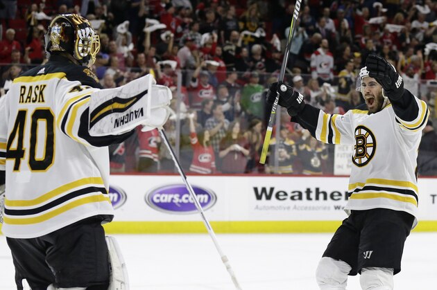 Boston Bruins goalie Tuukka Rask (40), of Finland, celebrates with John Moore following Game 4 of the NHL hockey Stanley Cup Eastern Conference finals against the Carolina Hurricanes in Raleigh, N.C., Thursday, May 16, 2019. Boston won 4-0 to advance to the Stanley Cup Final. (AP Photo/Gerry Broome)