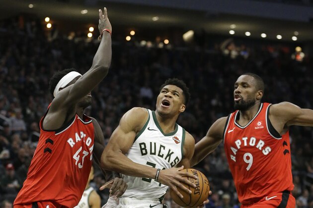 Milwaukee Bucks' Giannis Antetokounmpo, middle, drives to the basket between Toronto Raptors' Pascal Siakam (43) and Serge Ibaka (9) during the second half of an NBA basketball game, Saturday, Jan. 5, 2019, in Milwaukee. The Raptors won 123-116. (AP Photo/Aaron Gash)