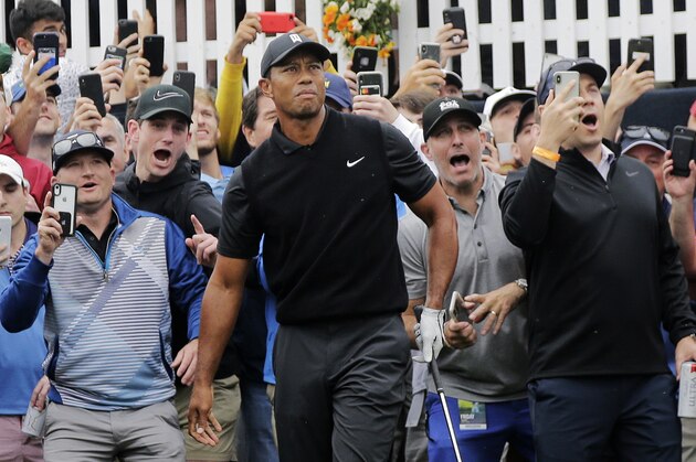 Tiger Woods watches his shot out of the rough on the first hole during the second round of the PGA Championship golf tournament, Friday, May 17, 2019, at Bethpage Black in Farmingdale, N.Y. (AP Photo/Seth Wenig)