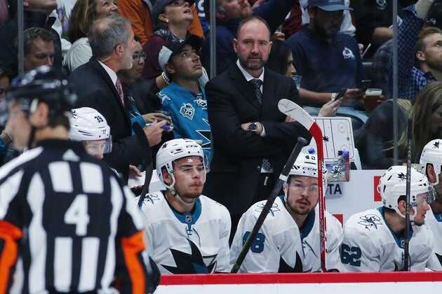 San Jose Sharks head coach Peter DeBoer, back, looks on against the Colorado Avalanche in the second period of Game 6 of an NHL hockey second-round playoff series, Monday, May 6, 2019, in Denver. (AP Photo/Jack Dempsey)