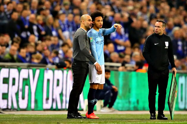 LONDON, ENGLAND - FEBRUARY 24: Manchester City manager Josep Guardiola talks with Leroy Sane of Manchester City on the sideline during the Carabao Cup Final between Chelsea and Manchester City at Wembley Stadium on February 24, 2019 in London, England. (Photo by Chris Brunskill/Fantasista/Getty Images)