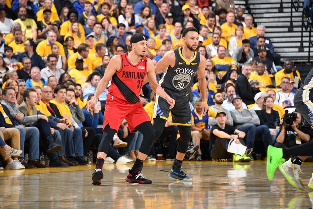 OAKLAND, CA - MAY 16: Seth Curry #31 of the Portland Trail Blazers and Stephen Curry #30 of the Golden State Warriors look on during Game Two of the Western Conference Finals on May 16, 2019 at ORACLE Arena in Oakland, California. NOTE TO USER: User expressly acknowledges and agrees that, by downloading and/or using this photograph, user is consenting to the terms and conditions of Getty Images License Agreement. Mandatory Copyright Notice: Copyright 2019 NBAE (Photo by Andrew D. Bernstein/NBAE via Getty Images)