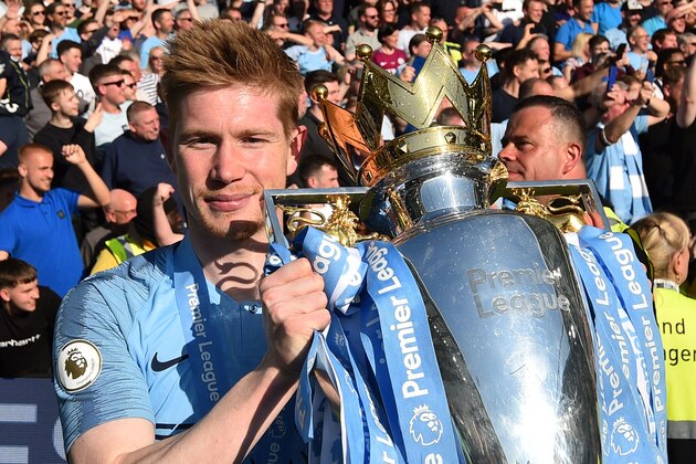 Manchester City's Belgian midfielder Kevin De Bruyne poses with the Premier League trophy after their 4-1 victory in the English Premier League football match between Brighton and Hove Albion and Manchester City at the American Express Community Stadium in Brighton, southern England on May 12, 2019. - Manchester City held off a titanic challenge from Liverpool to become the first side in a decade to retain the Premier League on Sunday by coming from behind to beat Brighton 4-1 on Sunday. (Photo by Glyn KIRK / AFP) / RESTRICTED TO EDITORIAL USE. No use with unauthorized audio, video, data, fixture lists, club/league logos or 'live' services. Online in-match use limited to 120 images. An additional 40 images may be used in extra time. No video emulation. Social media in-match use limited to 120 images. An additional 40 images may be used in extra time. No use in betting publications, games or single club/league/player publications. /         (Photo credit should read GLYN KIRK/AFP/Getty Images)