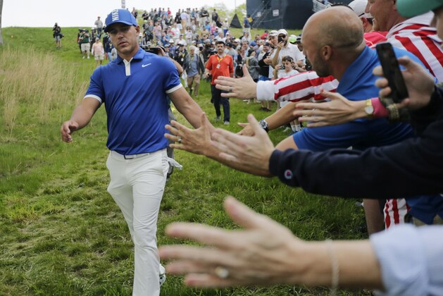 Brooks Koepka greets spectators as he walks down to the 15th tee during the second round of the PGA Championship golf tournament, Friday, May 17, 2019, at Bethpage Black in Farmingdale, N.Y. (AP Photo/Charles Krupa)