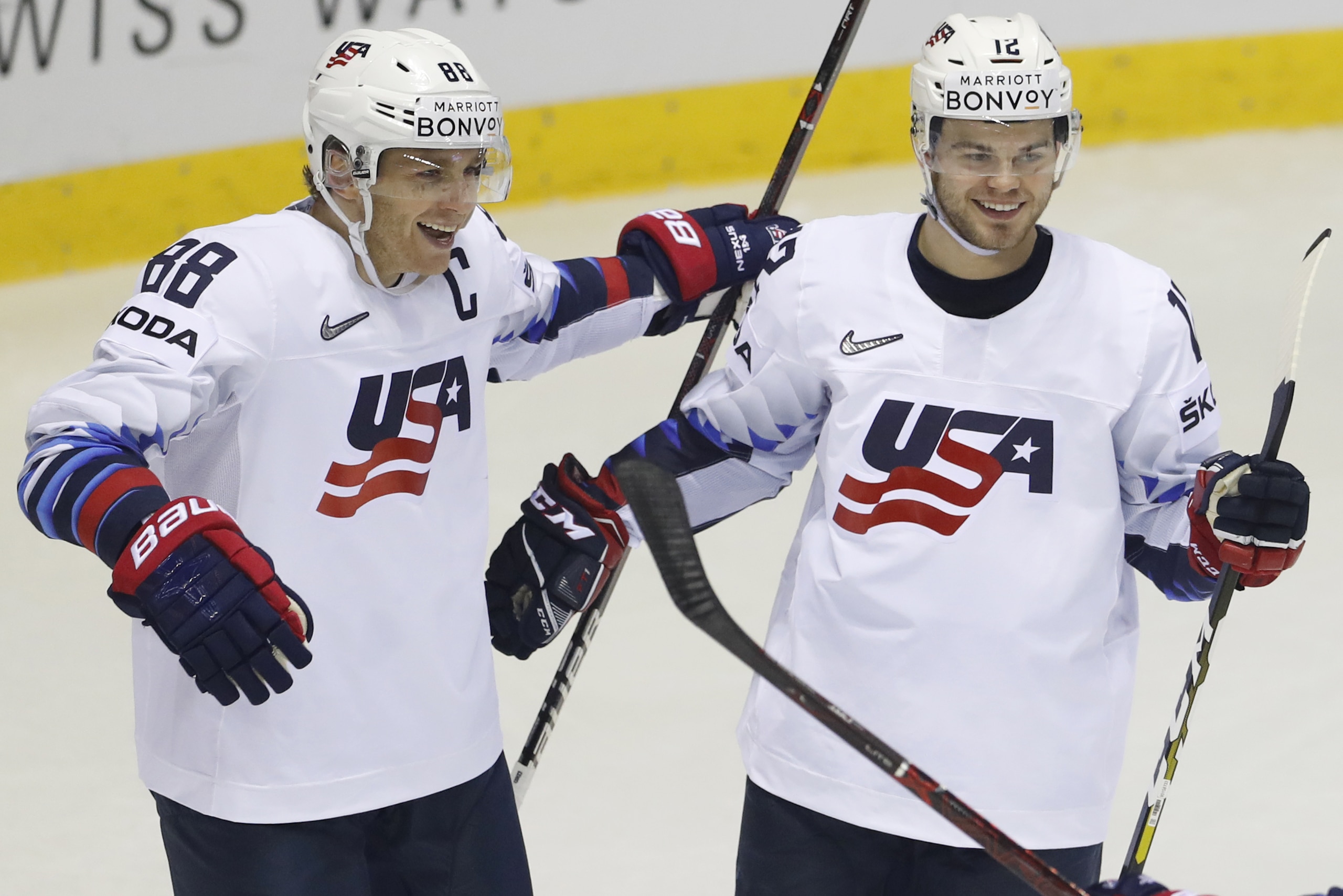 Alex Debrincat of the US, right, celebrates with teammate Patrick Kane, left, after scoring his sides fifth goal during the Ice Hockey World Championships group A match between Denmark and the United States at the Steel Arena in Kosice, Slovakia, Saturday, May 18, 2019. (AP Photo/Petr David Josek)