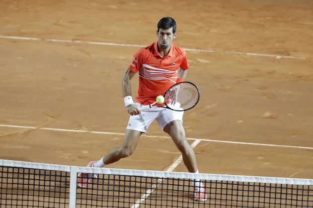 Novak Djokovic of Serbia returns the ball to Diego Schwartzman of Argentina during a semifinal match at the Italian Open tennis tournament, in Rome, Saturday, May 18, 2019. (AP Photo/Andrew Medichini)