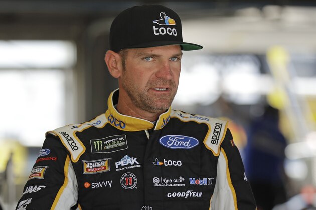 Clint Bowyer waits by his car before practice for Saturday's NASCAR All-Star Cup series auto race at Charlotte Motor Speedway in Concord, N.C., Friday, May 17, 2019. (AP Photo/Chuck Burton)