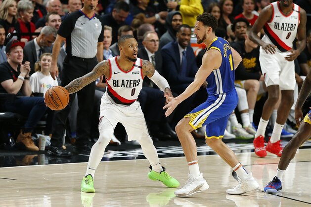 PORTLAND, OREGON - MAY 18: Damian Lillard #0 of the Portland Trail Blazers dribbles against Klay Thompson #11 of the Golden State Warriors in game three of the NBA Western Conference Finals at Moda Center on May 18, 2019 in Portland, Oregon. NOTE TO USER: User expressly acknowledges and agrees that, by downloading and or using this photograph, User is consenting to the terms and conditions of the Getty Images License Agreement. (Photo by Jonathan Ferrey/Getty Images)