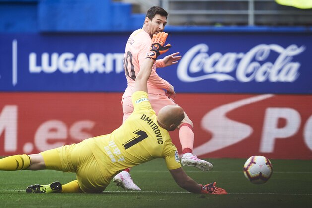 EIBAR, SPAIN - MAY 19: Lionel Messi of FC Barcelona scores a goal against Marko Dmitrovic of Eibar during the La Liga match between SD Eibar and FC Barcelona at Ipurua Municipal Stadium on May 19, 2019 in Eibar, Spain. (Photo by Juan Manuel Serrano Arce/Getty Images)