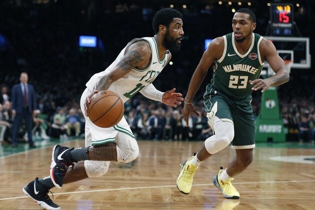 Boston Celtics' Kyrie Irving (11) drives past Milwaukee Bucks' Sterling Brown (23) during the second half of Game 4 of a second round NBA basketball playoff series in Boston, Monday, May 6, 2019. (AP Photo/Michael Dwyer)