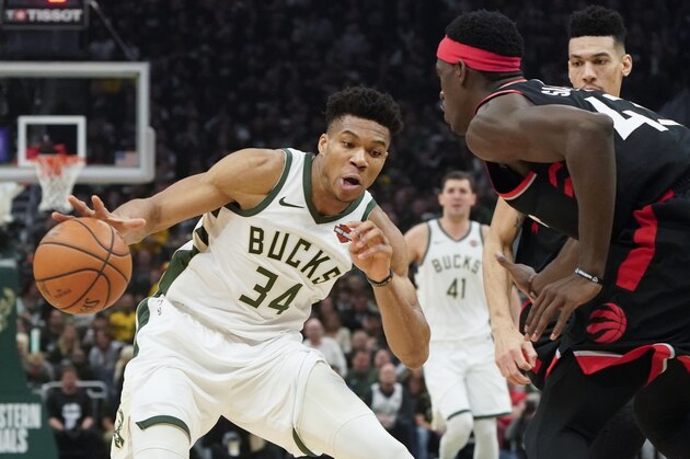 Milwaukee Bucks' Giannis Antetokounmpo tries to drive past Toronto Raptors' Pascal Siakam during the first half of Game 2 of the NBA Eastern Conference basketball playoff finals Friday, May 17, 2019, in Milwaukee. (AP Photo/Morry Gash)