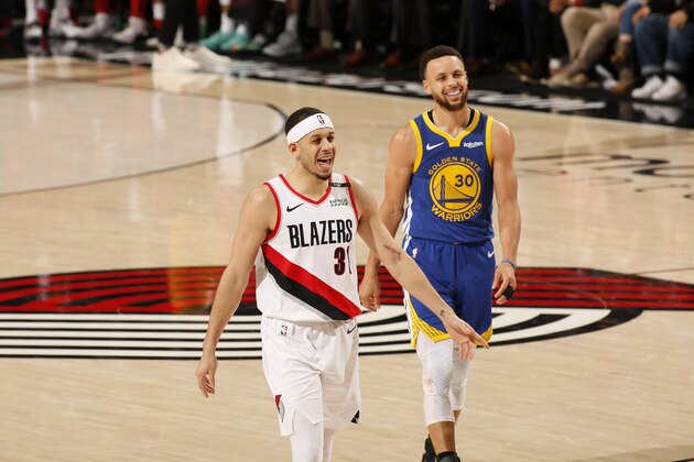 PORTLAND, OR - MAY 18: Seth Curry #31 of the Portland Trail Blazers and Stephen Curry #30 of the Golden State Warriors look on during Game Three of the Western Conference Finals of the 2019 NBA Playoffs on May 18, 2019 at the Moda Center in Portland, Oregon. NOTE TO USER: User expressly acknowledges and agrees that, by downloading and or using this photograph, user is consenting to the terms and conditions of the Getty Images License Agreement. Mandatory Copyright Notice: Copyright 2019 NBAE (Photo by Cameron Browne/NBAE via Getty Images)