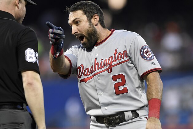 CORRECTS TO SAY EATON WAS SHOUTING TOWARD NEW YORK METS THIRD BASEMAN TODD FRAZIER - Washington Nationals' Adam Eaton, right, shouts toward New York Mets third baseman Todd Frazier after a double play was turned as first base umpire Mike Estabrook, left, stands by him in a baseball game Monday, May 20, 2019, in New York. (AP Photo/Sarah Stier)