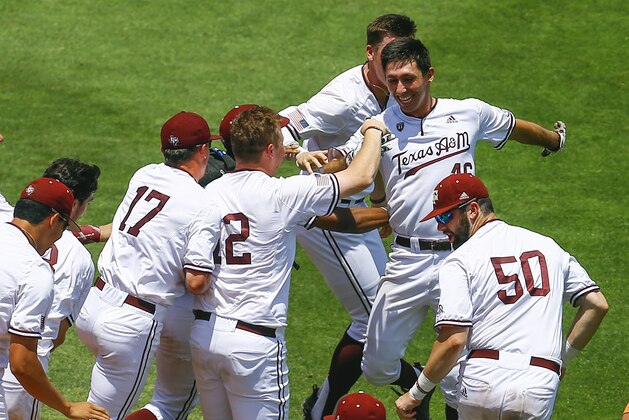 Texas A&M's Jonathan Ducoff, rear right, celebrates with teammates after hitting an RBI single during the 10th inning of the Southeastern Conference tournament NCAA college baseball game to defeat Florida 8-7, Tuesday, May 21, 2019, in Birmingham, Ala. (AP Photo/Butch Dill)