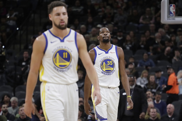 Golden State Warriors forward Kevin Durant (35) and guard Klay Thompson (11) walk off the court during a timeout during the first half of an NBA basketball game San Antonio Spurs, Sunday, Nov. 18, 2018, in San Antonio. (AP Photo/Eric Gay)