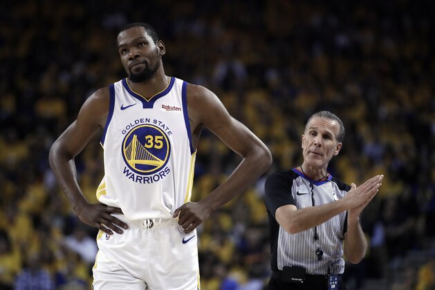 Golden State Warriors' Kevin Durant, left, walks away from referee Ken Mauer during the first half of Game 5 of the team's second-round NBA basketball playoff series against the Houston Rockets on  Wednesday, May 8, 2019, in Oakland, Calif. (AP Photo/Ben Margot)