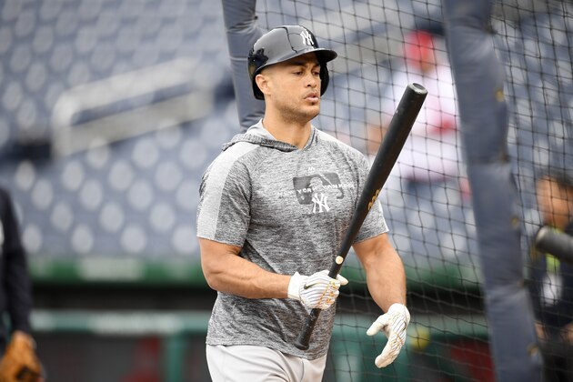 New York Yankees left fielder Giancarlo Stanton (27) stands on the field during batting practice before an exhibition baseball game against the Washington Nationals, Monday, March 25, 2019, in Washington. (AP Photo/Nick Wass)