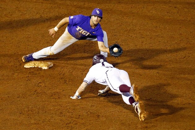 LSU shortstop Josh Smith (4) catches the ball to tag Mississippi State's Tanner Allen (5) out as he slides into second base during the 15th inning of the Southeastern Conference tournament NCAA college baseball game, Thursday, May 23, 2019, in Hoover, Ala. (AP Photo/Butch Dill)