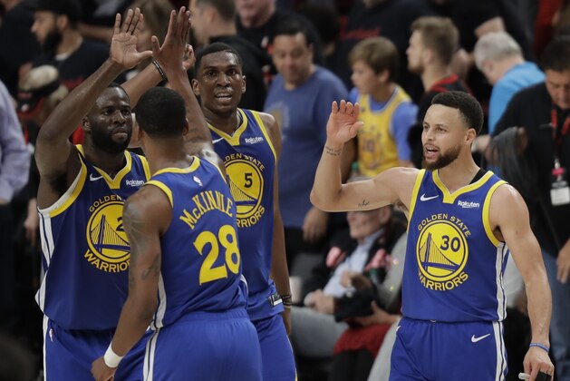 Golden State Warriors guard Stephen Curry, right, greets teammates during the second half of Game 3 of the NBA basketball playoffs Western Conference finals against the Portland Trail Blazers, Saturday, May 18, 2019, in Portland, Ore. The Warriors won 110-99. (AP Photo/Ted S. Warren)