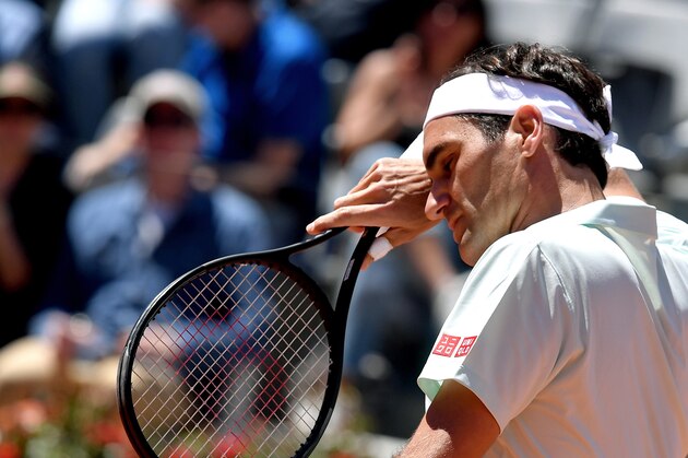 Switzerland's Roger Federer wipes his face during his ATP Masters tournament tennis match against Portugal's Joao Sousa at the Foro Italico in Rome on May 16, 2019. - World number three Roger Federer pulled out of the Italian Open before his quarter-final match on May 17, 2019 with a right leg injury. Federer, a four-time Rome finalist, had been due to meet Greek eighth seed Stefanos Tsitsipas for a place in the semi-finals. (Photo by Tiziana FABI / AFP)        (Photo credit should read TIZIANA FABI/AFP/Getty Images)