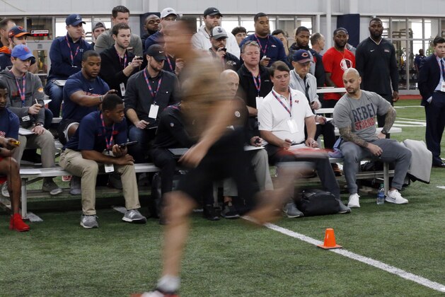 NFL scouts and assistant coaches time former Mississippi football players as they run 40-yard dashes, as part of combine testing during Pro Day at Mississippi, Friday, March 29, 2019, in Oxford, Miss. (AP Photo/Rogelio V. Solis)