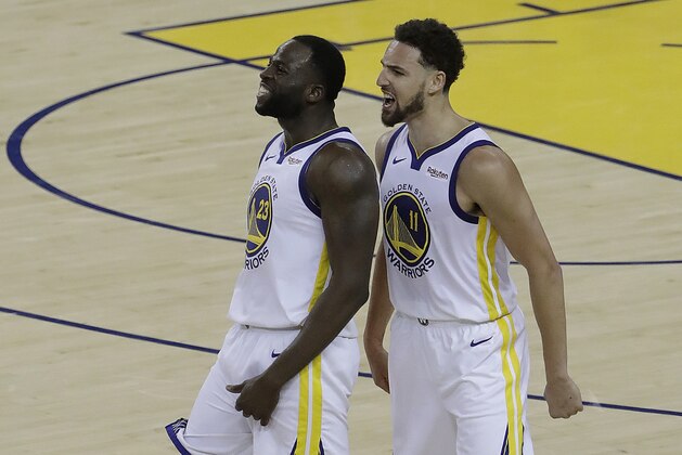 Golden State Warriors forward Draymond Green, left, celebrates with guard Klay Thompson during the second half of Game 1 of the team's NBA basketball playoffs Western Conference finals against the Portland Trail Blazers in Oakland, Calif., Tuesday, May 14, 2019. (AP Photo/Jeff Chiu)