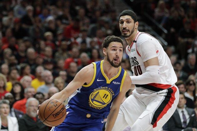 Golden State Warriors guard Klay Thompson (11) drives around Portland Trail Blazers center Enes Kanter, right, during the first half of Game 3 of the NBA basketball playoffs Western Conference finals, Saturday, May 18, 2019, in Portland, Ore. (AP Photo/Ted S. Warren)