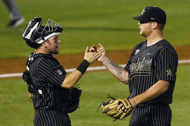 Vanderbilt catcher Phillip Clarke, left, congratulates pitcher Tyler Brown (21) after Vanderbilt defeated Mississippi State 1-0 in a Southeastern Conference tournament NCAA college baseball game Thursday, May 23, 2019, in Hoover, Ala. (AP Photo/Butch Dill)