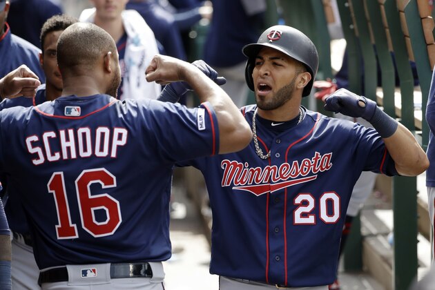 Minnesota Twins' Eddie Rosario (20) celebrates his solo home run in the dugout with teammate Jonathan Schoop (16) during the eighth inning of the team's baseball game against the Los Angeles Angels on Thursday, May 23, 2019, in Anaheim, Calif. (AP Photo/Marcio Jose Sanchez)