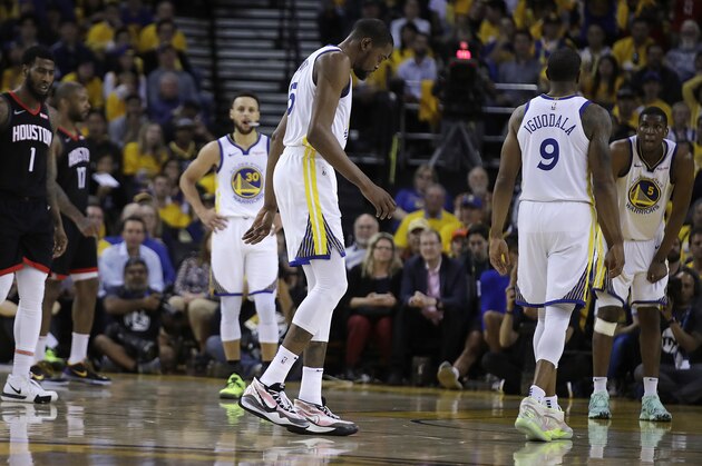 Golden State Warriors' Kevin Durant, center, limps off the court during the second half of Game 5 of the team's second-round NBA basketball playoff series against the Houston Rockets on Wednesday, May 8, 2019, in Oakland, Calif. (AP Photo/Ben Margot)