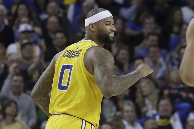 Golden State Warriors center DeMarcus Cousins smiles after scoring against the Denver Nuggets during an NBA basketball game in Oakland, Calif., Tuesday, April 2, 2019. (AP Photo/Jeff Chiu)