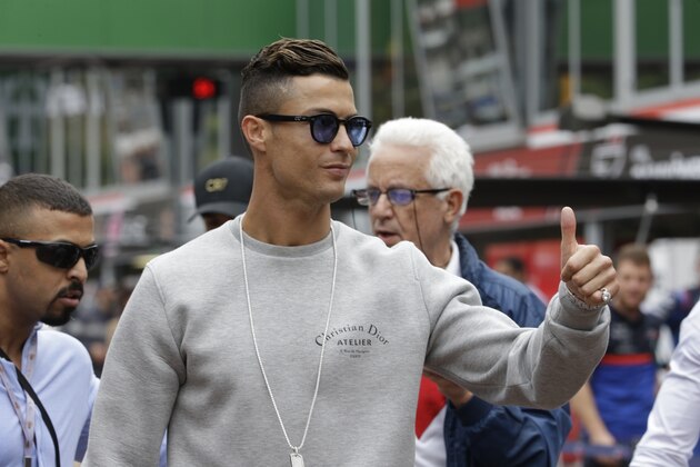 Cristiano Ronaldo applauds fans at the pit line ahead of the second practice session at the Monaco racetrack, in Monaco, Thursday, May 23, 2019. The Formula one race will be held on Sunday. (AP Photo/Luca Bruno)