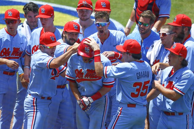 Mississippi's Grae Kessinger, center, celebrates with teammates after hitting a two-run home run against Georgia during the fifth inning of an NCAA college baseball game at the Southeastern Conference tournament, Saturday, May 25, 2019, in Hoover, Ala. (AP Photo/Butch Dill)