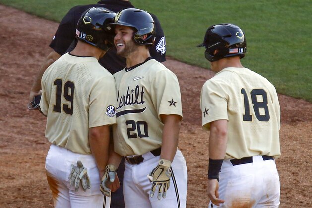 Vanderbilt's Ty Duvall (20) celebrates with Stephen Scott (19) and Pat DeMarco (18) after hitting a three-run home run during the sixth inning of the team's Southeastern Conference tournament NCAA college baseball game against LSU, Saturday, May 25, 2019, in Hoover, Ala. (AP Photo/Butch Dill)