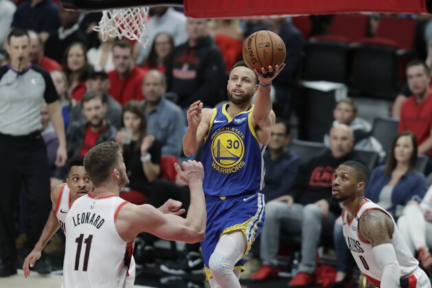 Golden State Warriors guard Stephen Curry (30) puts up a shot against Portland Trail Blazers forward Meyers Leonard (11) during the second half of Game 4 of the NBA basketball playoffs Western Conference finals, Monday, May 20, 2019, in Portland, Ore. The Warriors won 119-117 in overtime. (AP Photo/Ted S. Warren)