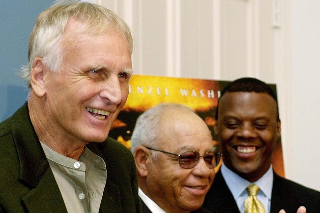 WASHINGTON, :  US Rep. J.C, Watts, Jr (R-OK) (R) looks on as former Alexandria, Virginia high school foootball coaches Bill Yoast (L) and Herman Boone (C) discuss the Walt Disney Company's latest film
