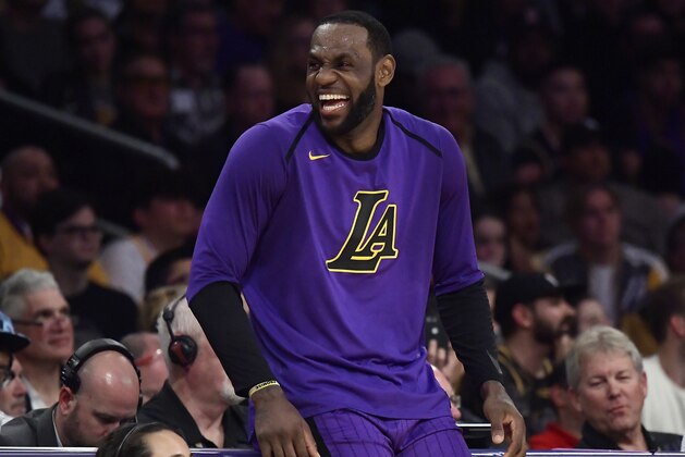 Los Angeles Lakers forward LeBron James laughs as he waits to check in to the team's NBA basketball game against the Charlotte Hornets during the second half Friday, March 29, 2019, in Los Angeles. The Lakers won 129-115. (AP Photo/Mark J. Terrill)