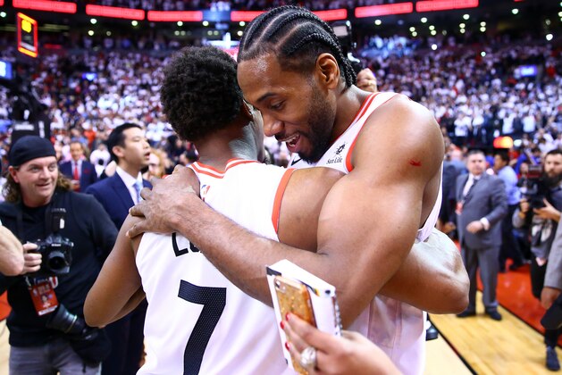 TORONTO, ON - MAY 12:  Kawhi Leonard #2 (R) of the Toronto Raptors speaks with Kyle Lowry #7 after sinking a buzzer beater to win Game Seven of the second round of the 2019 NBA Playoffs against the Philadelphia 76ers at Scotiabank Arena on May 12, 2019 in Toronto, Canada.  NOTE TO USER: User expressly acknowledges and agrees that, by downloading and or using this photograph, User is consenting to the terms and conditions of the Getty Images License Agreement.  (Photo by Vaughn Ridley/Getty Images)