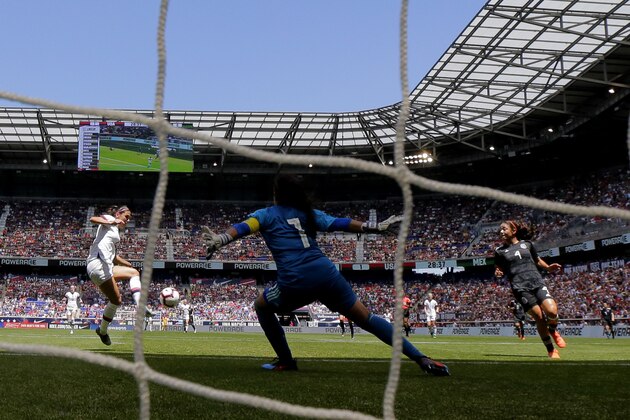 Unites States forward Alex Morgan, left, tries to shoot against Mexico goalkeeper Cecilia Santiago (1) during the first half of an international friendly soccer match, Sunday, May 26, 2019, in Harrison, N.J. (AP Photo/Julio Cortez)