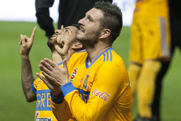 Tigres' Andre Gignac, front, and Javier Aquino kneel after winning the final Mexican soccer league championship soccer game against Monterrey in Monterrey, Mexico, Sunday, Dec. 10, 2017. (AP Photo/Christian Palma)